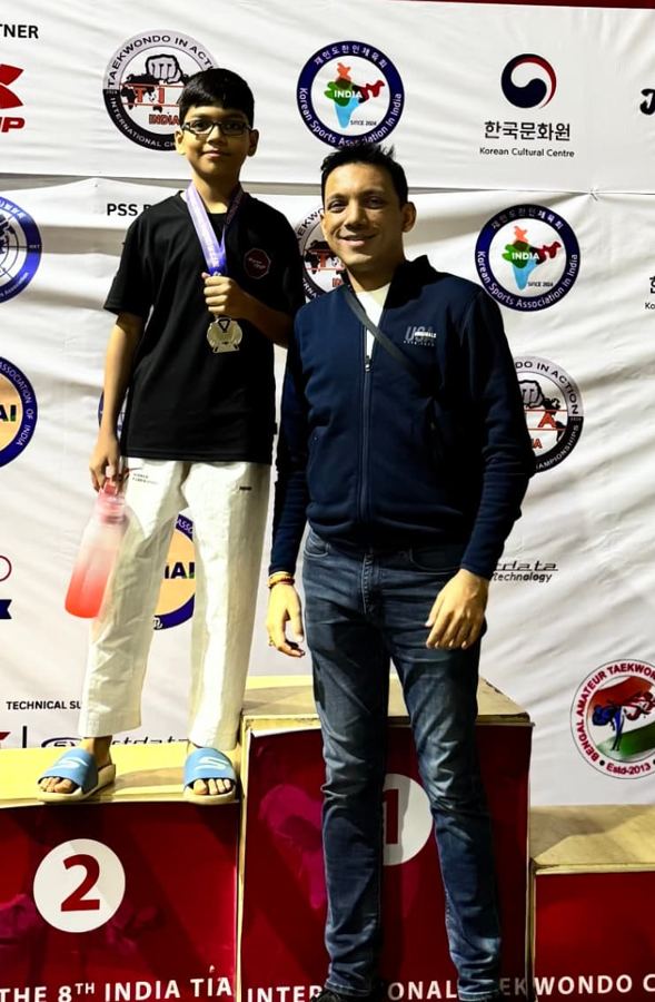 Rishabh Rajsekar on the podium with his medal at the 8th India TIA Open Taekwondo Championship